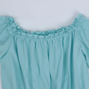Detailed view of elastic off-shoulder neckline with ruffle trim on light blue top