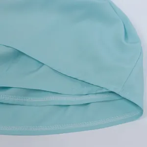 Macro shot of light blue layered ruffles with detailed stitching on hemline
