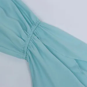 Detail of light blue ruffled sleeve with elastic shirring on off-shoulder summer top