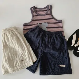 Detailed flat lay of boys' cotton tank top with elephant print and shorts set