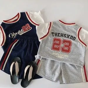 Flat lay view of navy and grey kids basketball sets with 23 print on cotton fabric