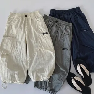 Detail of kids cargo pants with elastic waist and drawstring hem in three colors