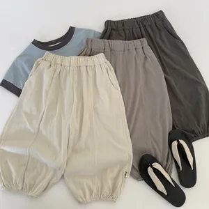Flat lay of cotton linen kids set featuring Paddington bear style pants and tee