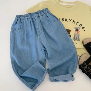 Detail of light blue boys' denim pants featuring elastic waistband and side pockets