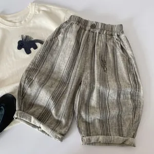 Close-up of kids grey striped cotton pants with elastic waist and bear embroidery