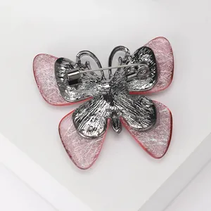 Pink acrylic butterfly brooch with silver wire mesh detail and gunmetal pin back