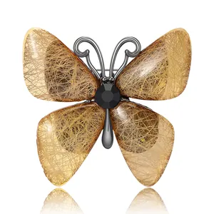 Elegant butterfly brooch with gold translucent wings and black gemstone for blazers