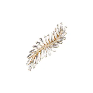 Macro detail of leaf-shaped gold hair clip with crystal marquise rhinestones