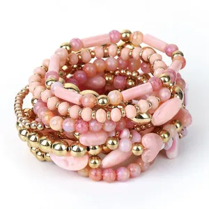 Set di 11 braccialetti fatti a mano con pietre rosa e dettagli metallici dorati
