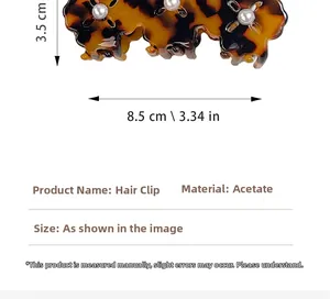 Detail view of tortoiseshell acetate claw clip with pearl accents, size 8.5cm x 3.5cm