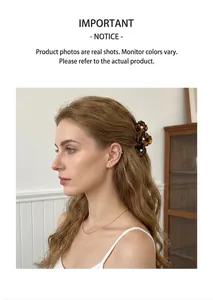 Detail of tortoise shell hair claw with three floral shapes and central pearl accents