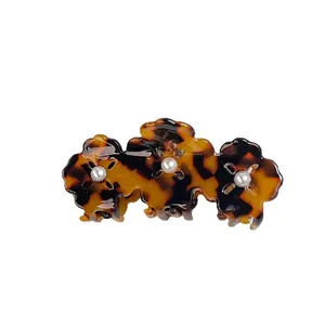 Three-flower acetate claw clip with classic tortoiseshell pattern and pearl centers