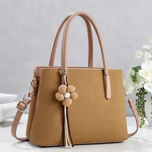 Khaki lychee texture tote bag with leather handles and woven floral tassel charm