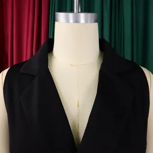 Detail view of the black sleeveless jumpsuit showing the notched lapel and v-neckline