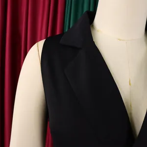 Detail of black notched lapel sleeveless vest with professional tailoring and firm fabric