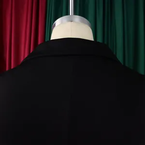 Detail of the high-quality stitching on the back collar and shoulders of a black jumpsuit
