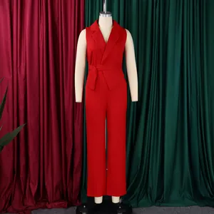 Detail view of red sleeveless jumpsuit with notched lapel and tie waist belt on mannequin