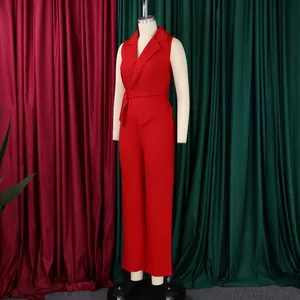 Detail of red sleeveless jumpsuit showing lapel collar and waist tie on mannequin