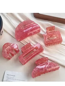 Set di 5 mollette per capelli in acrilico rosa marmorizzato in varie forme geometriche su tessuto