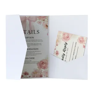 Close-up of pocket wedding invitation set with pink watercolor floral design and inserts