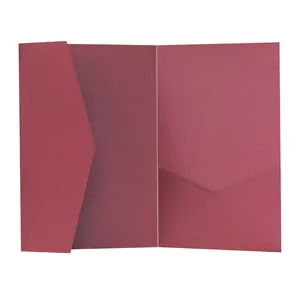 Macro shot of wine red textured paper wedding invitation pocket with V-cut folder