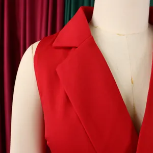 Detail of red sleeveless jumpsuit featuring a classic notched lapel and premium woven texture