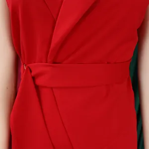 Detailed macro view of the waist area on a red sleeveless jumpsuit with a matching belt