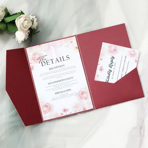 Macro detail of burgundy trifold wedding invitation set with floral detail cards