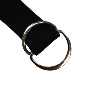 Detailed macro view of black fabric waist belt with a polished silver double-ring buckle
