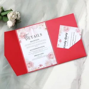 Macro view of wedding invitation suite with floral details card and red pocket folder