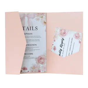 Detail view of pink laser cut wedding invitation with floral insert and RSVP cards