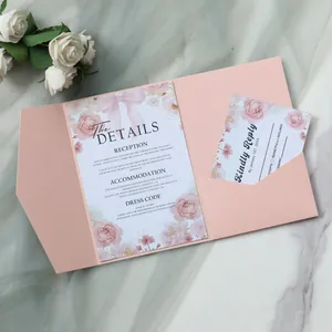Detail of pink pocket wedding invitation with floral patterns and a ribbon bow