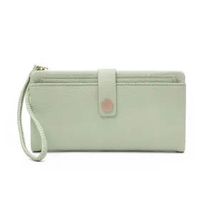 Close-up of mint green lychee textured leather long wallet with snap button and wristlet