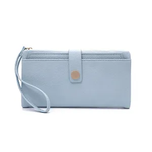 Detail of light blue lychee pattern faux leather wallet with wristlet and snap closure