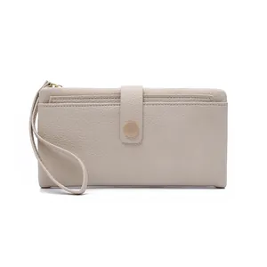 Detailed macro view of beige pebble grain leather texture and metallic snap buckle on clutch