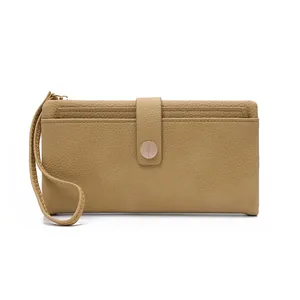 Close-up of khaki pebbled leather texture with metal buckle and wrist strap detail