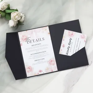 Close-up of elegant floral wedding invitation suite with black trifold pocket and detail cards