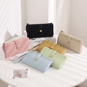Various colors of lychee pattern long wallets with wrist straps and snap buttons
