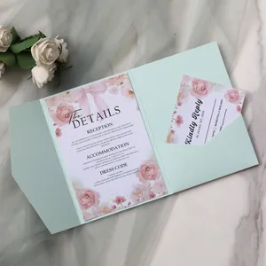 Detail view of mint green laser cut wedding invitation set with floral inserts