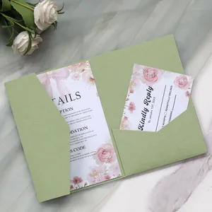 Elegant sage green wedding invitation set with floral detail on marble surface