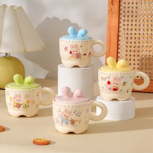 Detail of creative ceramic mugs with 3D bunny ear lids and cartoon rabbit illustrations