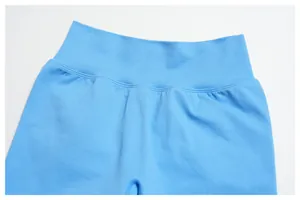 Detailed view of the wide ribbed high waistband on seamless sky blue yoga shorts