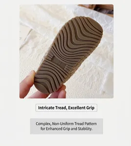 Close-up of non-slip rubber sole with size 23 and wave texture on dark brown baby shoes