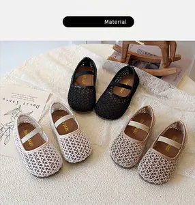 Detail view of baby Mary Jane shoes with woven mesh upper in black and cream colors