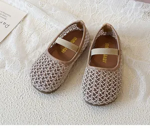 Detailed top view of beige mesh kids Mary Jane shoes with elastic strap on lace background