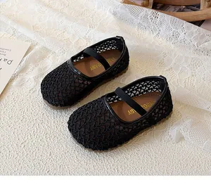 Close-up of black breathable mesh baby shoes with elastic straps and non-slip rubber soles
