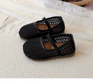 Detail of kids black mesh Mary Jane flats with elastic strap and rubber sole