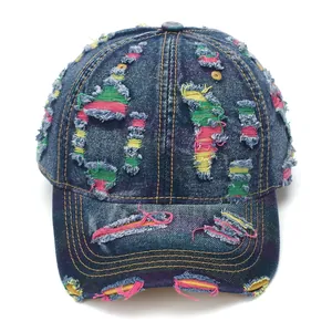 Distressed blue denim baseball cap with colorful stitching and retro ripped details