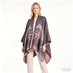 Close-up of gray and pink cashmere poncho featuring an artistic horse pattern
