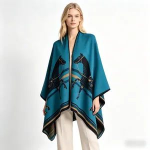 Detail of luxurious peacock blue cashmere-like poncho shawl with artistic horse pattern